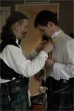 Dad adjusts brother Andrew's cravat